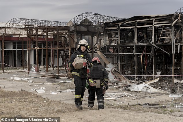 State Emergency Service workers clean up debris at Barabashovo market after Russian aerial attack on October 1, 2025 in Kharkiv, Ukraine