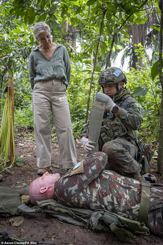 The Duchess of Edinburgh watches as soldiers from the MONUSCO Jungle Warfare Training Team demonstrate a medical emergency during a peace keeping engagement at the Jungle Ground in Beni