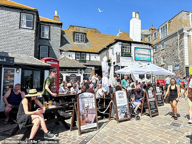 Visitor figures to Cornwall slumped by 10 to 12 per cent in 2024, and this week Visit Cornwall, which promotes the region to the UK and the rest of the world, announced it went bust (Pictured: The Sloop Inn, St Ives)