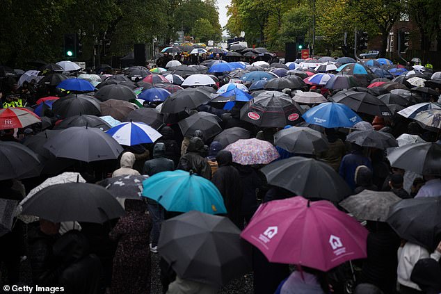 Attendees at the vigil stood in the Manchester rain to listen to speakers