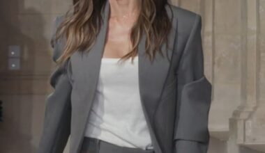 Beaming Victoria Beckham pulled her proud husband David in for a passionate kiss following her Paris Fashion Week show on Friday