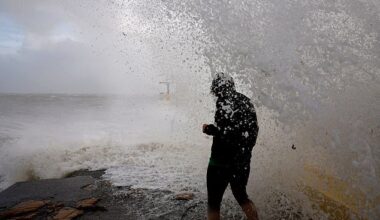 A woman is caught by a large wave at Blackrock diving tower in Galway, Ireland as Storm Amy unleashes over the British isles