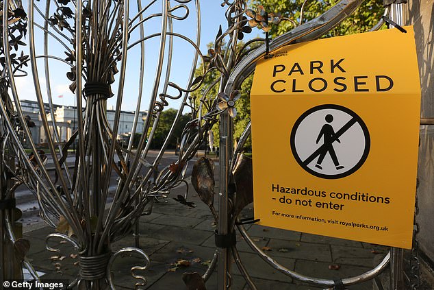 In the capital, all eight of London's royal parks will be closed on Saturday because of expected strong winds. Pictured: A sign posted to the gates of Hyde Park