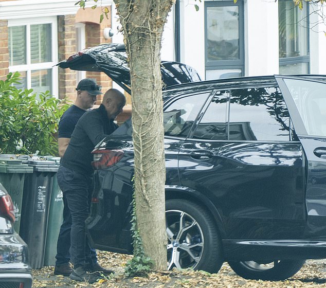 A close-protection officer helps Mr Tarry move bags and boxes in a BMW X5