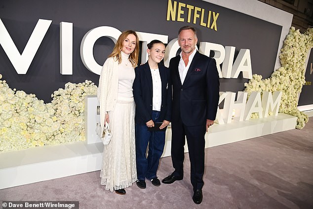 She was dressed in her trademark white as she posed for the cameras with her stepdaughter Olivia and husband Christian