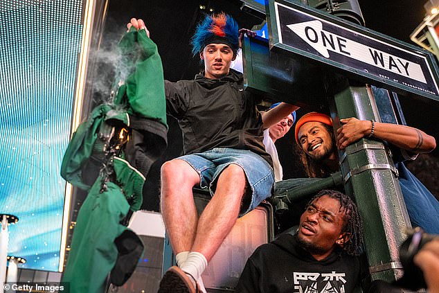 Fans climbed signs and light poles to celebrate the Knicks' first conference final in 25 years