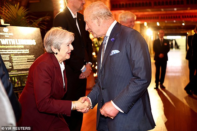 King Charles shaking the hand of former prime minister Theresa May