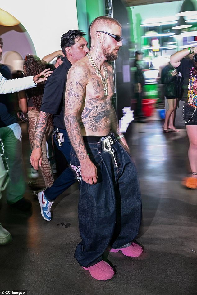 The Grammy-winning pop star, 31, showed off his tattoos as he was spotted shirtless with layered gold chains around his neck