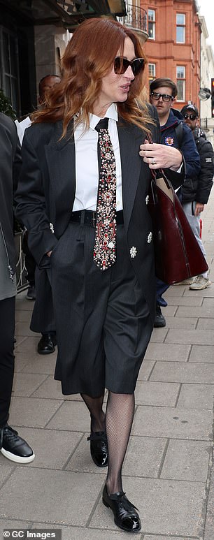 She accessorised her outfit with a dark cherry coloured shoulder bag and pair of dark sunglasses