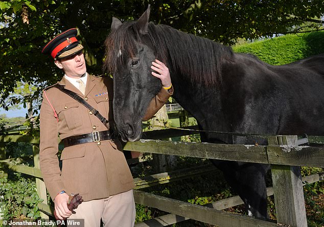 Life Guard Squadron Leader Major Tom Stewart says goodbye to Household Cavalry horse Quaker as he begins his retirement