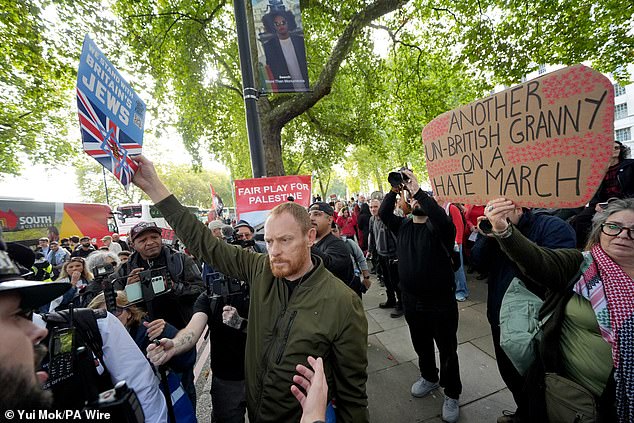 An anti-Palestine protester from the group Our Fight, a pro-Israel organisation, stands amidst pro-Palestine protesters on Saturday morning