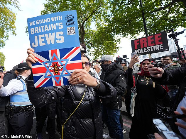 A demonstrator from Our Fight, a pro-Israel organisation, is seen in the crowd among pro-Palestinian supporters, ahead of a Palestine Solidarity Campaign march from Victoria Embankment to Downing Street, central London