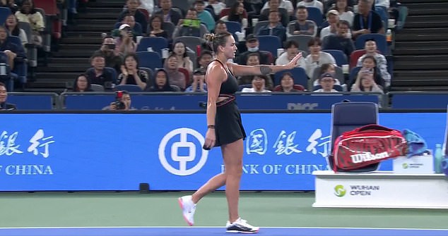 Sabalenka raised her hand in apology after nearly hitting a ball boy by the side of the court