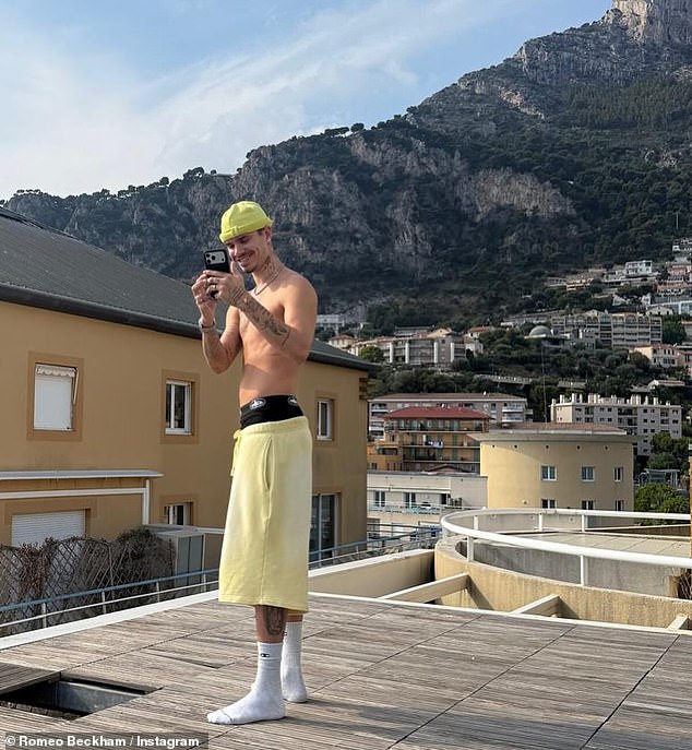 The son of David and Victoria Beckham, 23, beamed for photos flashing his new dazzling tooth bling as he donned a pair of black boxers and long yellow shorts