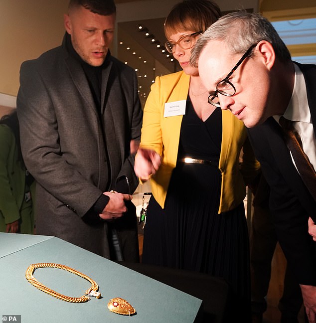 Mr Clarke (left) is seen looking at the pendant at the British Museum alongside Tory arts minister Lord Parkinson, January 2023