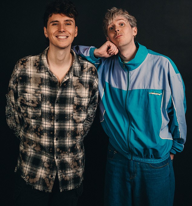 Leaning on one another, with huge smiles, Dan Howell and Phil Lester look like the perfect, happy couple