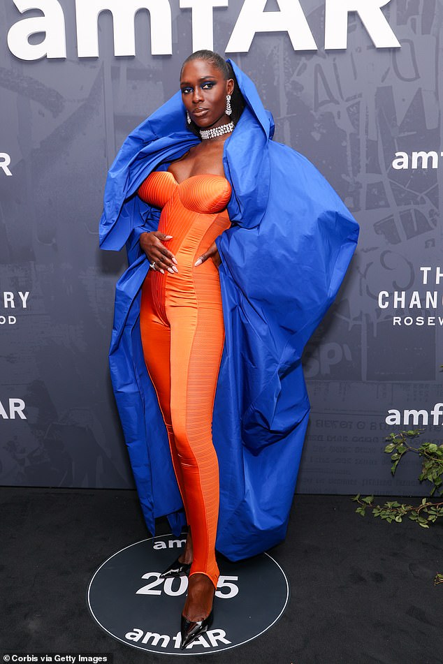 Meanwhile, Jodie, 39, flaunted her sensational figure in a strapless orange satin catsuit