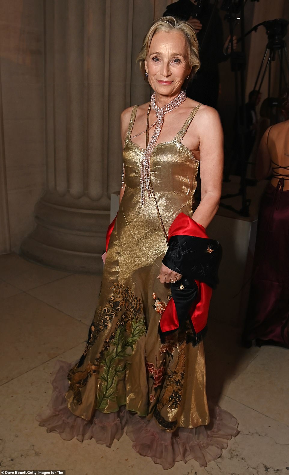 Actress Dame Kristin Scott Thomas also opted for a metallic look, wearing a sleeveless gold gown adorned with floral embroidery and chiffon ruffles