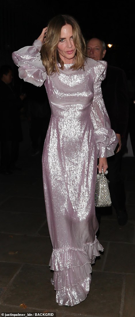 Trinny's dress had ruffles at the bottom and balloon sleeves, with the star accessorising with a silver beaded handbag and metallic open-toed heels