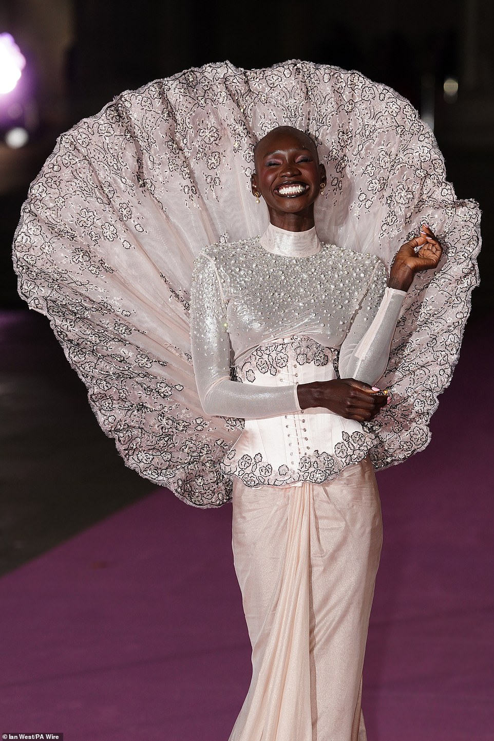 Model Adot Gak turned heads in a white and silver high-neck beaded top wtih a lace corset, as well as a pale pink wrap skirt