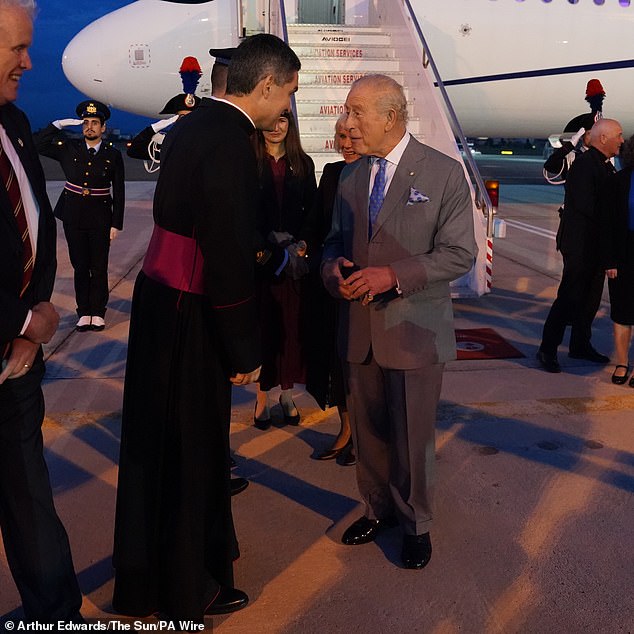 King Charles greets people as he stepped off the plane with Queen Camilla at Ciampino Airport