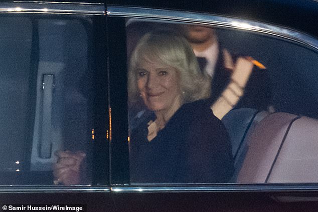 Queen Camilla pictured smiling at onlookers from the car as she and King Charles were whisked away from the airport