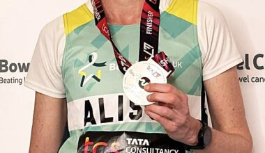 Alison Crooks shows off her medal after completing the London marathon in 2023 to raise money for charity Bowel Cancer UK
