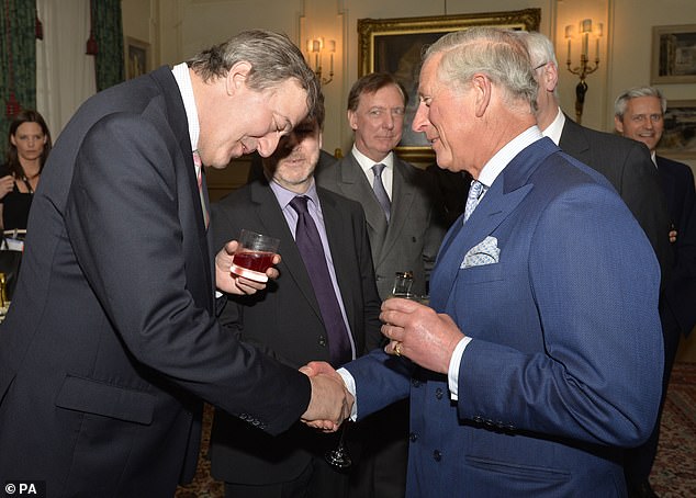 Charles shakes hands with Stephen Fry at a Samaritans reception at Clarence House in 2013