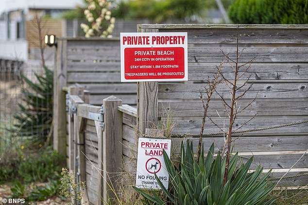 'Private' beach signs are pictured. One reads: '24h CCTV in operation. Stay within 1.8m footpath. Trespassers will be prosecuted'
