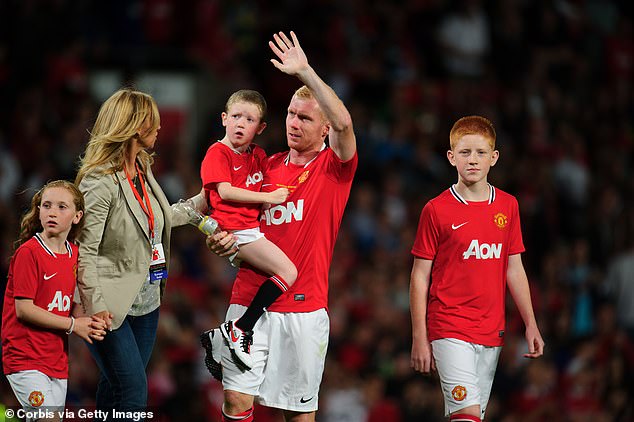 The 20-year-old was diagnosed when he was two-and-a-half years old (pictured carried by Scholes)