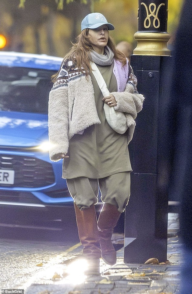 She layered a jacket, vest, and another jacket over leggings and knee-high boots, looking effortlessly chic ¿ a far cry from her red carpet days