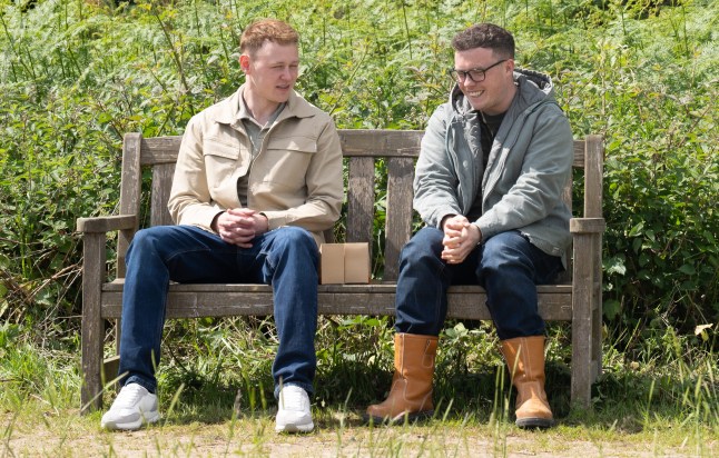 Mike and Vinny chat on a bench in Emmerdale