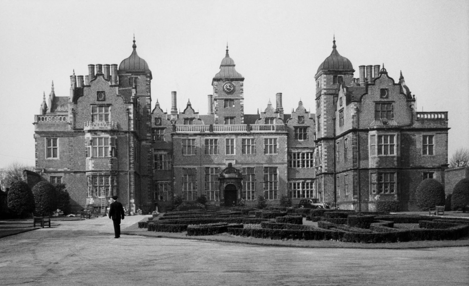 Image may contain Architecture Building Housing Person House Manor Bench and Furniture