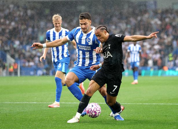 Xavi Simons of Tottenham Hotspur is tackled by Diego Coppola of Brighton & Hove Albion during the Premier League match between Brighton & Hove Albion and Tottenham Hotspur