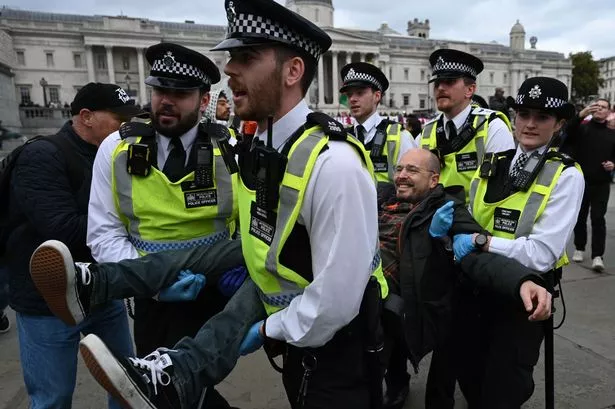 Police take a protestor into custody as people stage a demonstration to demand the British government to lift its ban on Palestine Action group in London