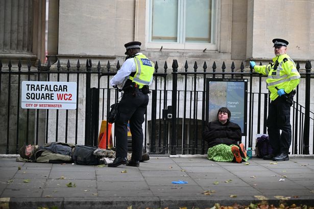 Police take a protestor into custody 