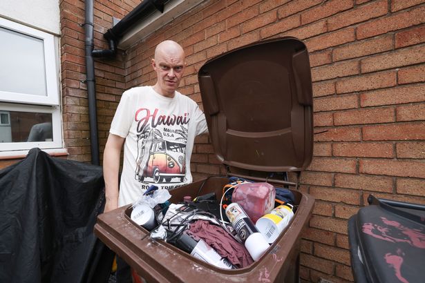 Michael Farrell with the bins in his yard at home in Litherland