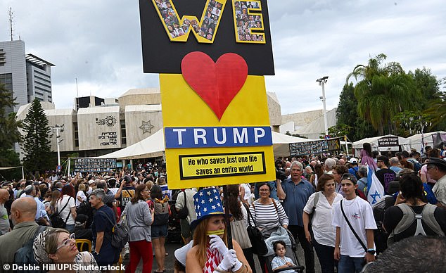 Mandatory Credit: Photo by Debbie Hill/UPI/Shutterstock (15525743o) A woman holds a placard saying "WE LOVE Trump" as people gather in Hostage Square in Tel Aviv to celebrate the agreement for U.S. President Donald Trump's peace plan, to end the Israel-Hamas war, on Thursday, October 9, 2025. The first phase of the plan will include the release of all hostages, Palestinian prisoners and the entry of humanitarian aid to Gaza. October 9, 2025. Israelis Celebrate The Ceasefire Agreement In Hostage Square, Tel Aviv, Israel - 09 Oct 2025