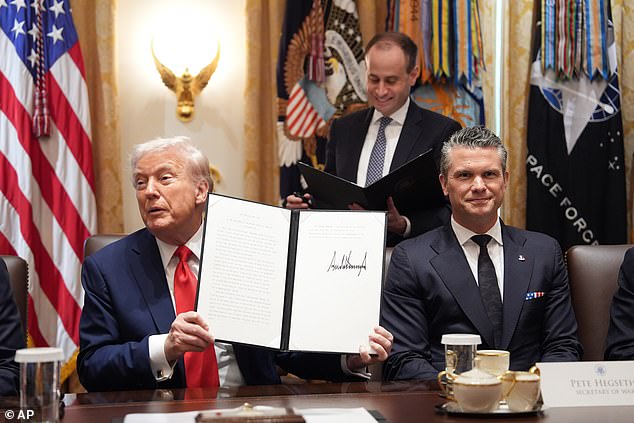 President Donald Trump speaks during a cabinet meeting at the White House, Thursday, Oct. 9, 2025, in Washington, as Defense Secretary Pete Hegseth look on. (AP Photo/Evan Vucci)