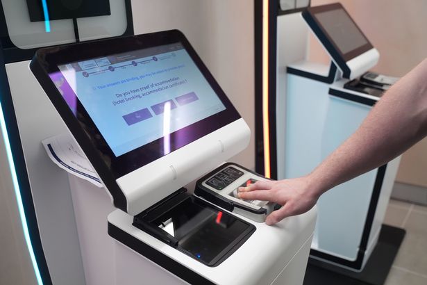 A person uses a EES kiosk during the preview at Kings Cross St Pancras for the Eurostar European Union entry/exit system (EES)