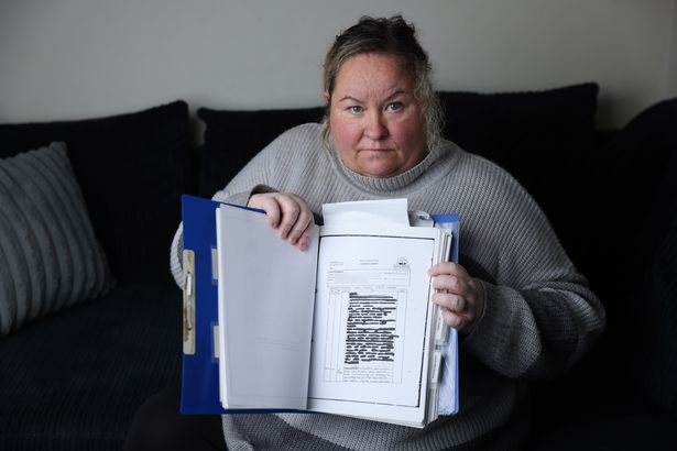 Nichola Anne with records from her time spent in care