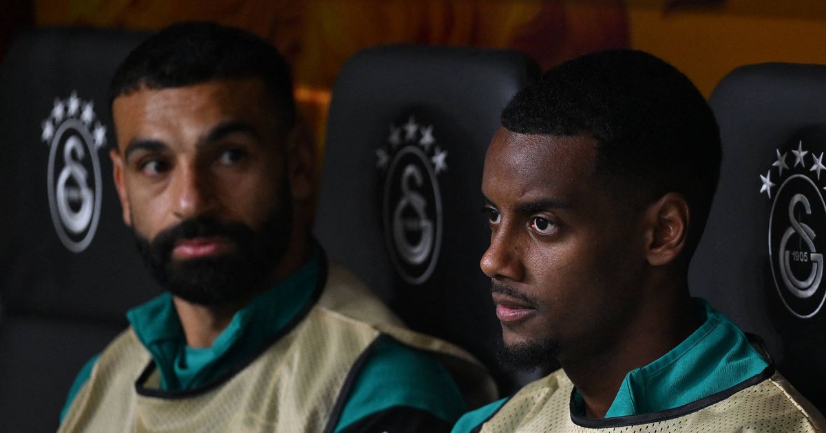 Liverpool's Swedish forward #09 Alexander Isak (C) looks on from the bench as he sits next to Liverpool's Egyptian forward #11 Mohamed Salah (L) and Liverpool's Argentine midfielder #10 Alexis Mac Allister (R) during the UEFA Champions League first round day 2 football match between Galatasaray (TUR) and Liverpool (ENG) at the Ali Sami Yen Spor Kompleksi in Istanbul on September 17, 2025. (Photo by Yasin AKGUL / AFP) (Photo by YASIN AKGUL/AFP via Getty Images)