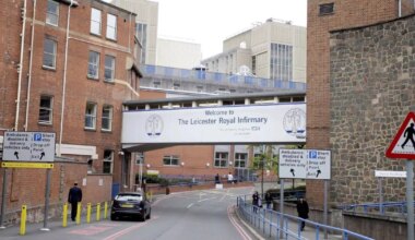 Motion blurred police car or ambulance speeding down street in London, horizontal orientation, England, UK.