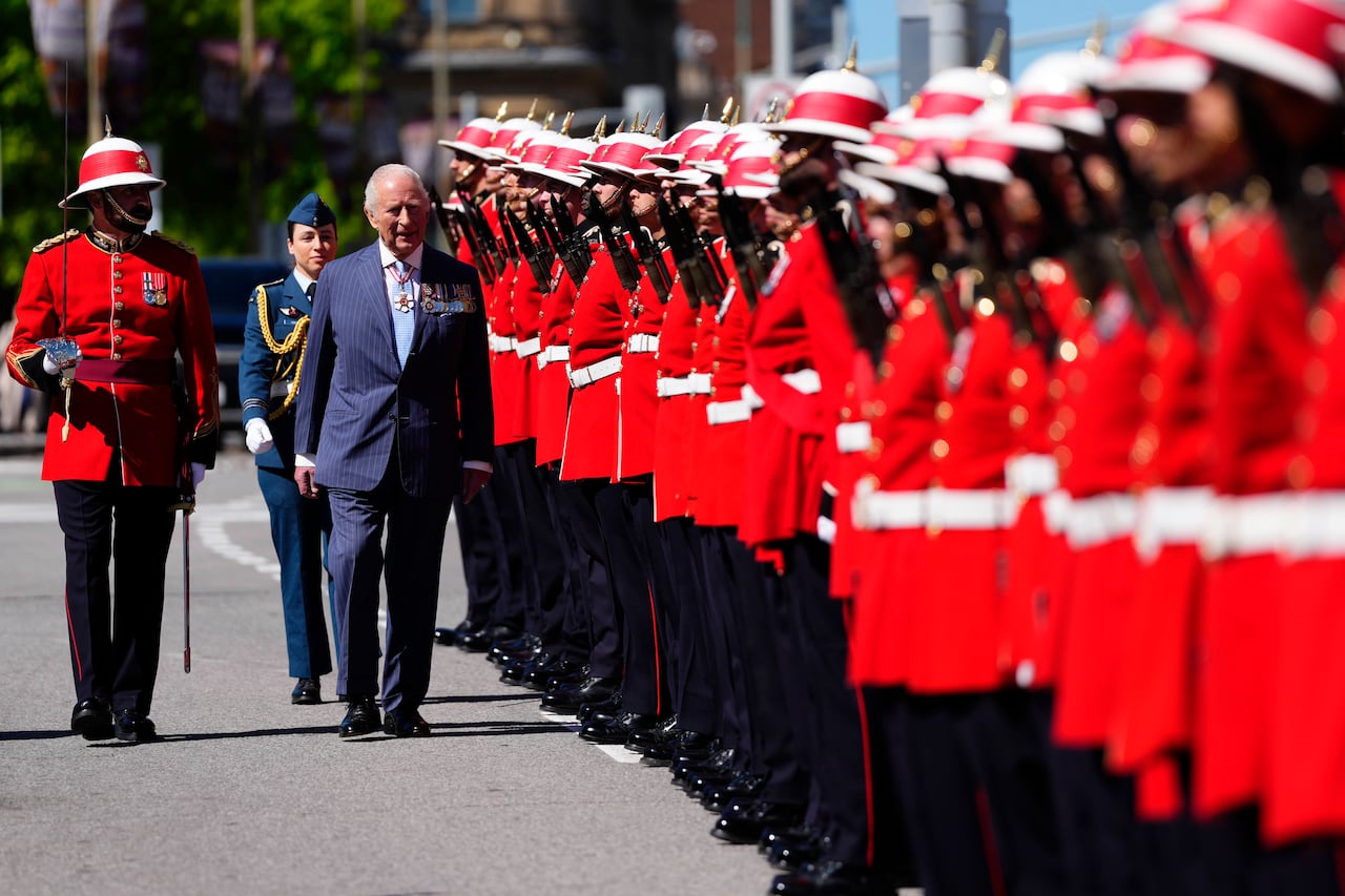 King Charles inspects an honour guard at the Senate of Canada building in Ottawa before reading the throne speech during a royal visit, on Tuesday, May 27, 2025.