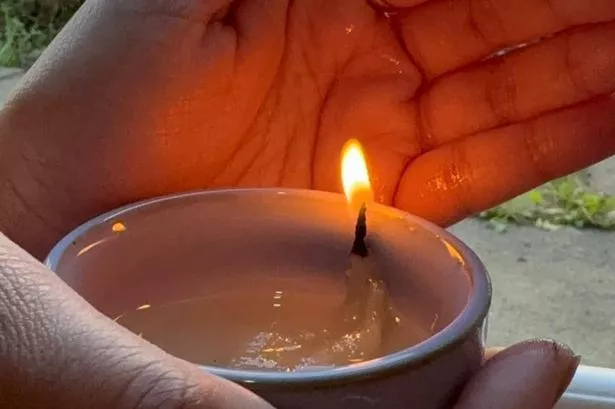 A woman's hands holding a lamp