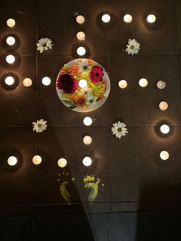 A swastika drawn out in tea lights