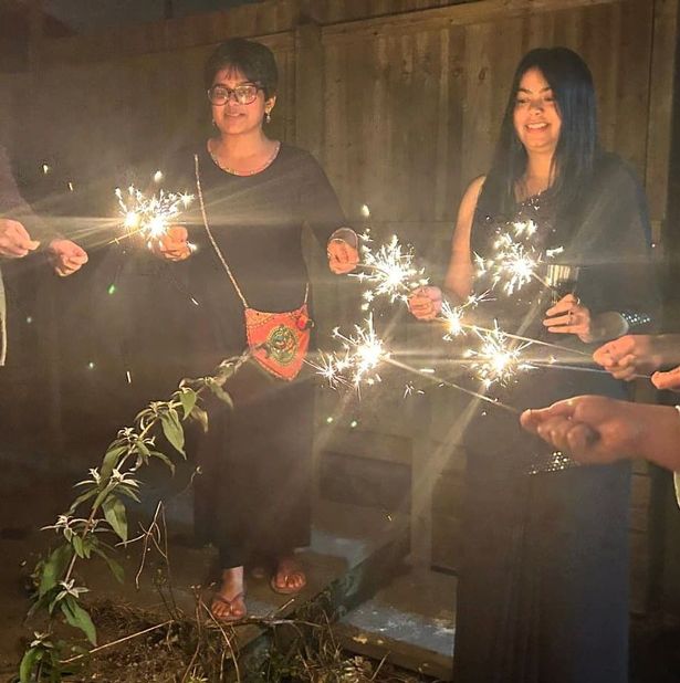 Two women holding sparklers