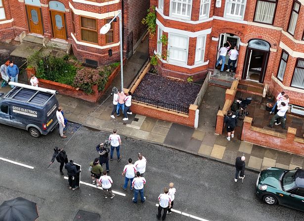 Alan Cumming was seen on location in Salford as he was filmed being held back by two men