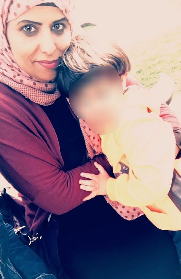 Amnah pictured holding her son whose face is blurred out
