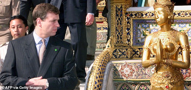 Britain's Prince Andrew looks at a gold-covered statue of a Thai deity 02 December, 1999 while visiting Bangkok's Grand Palace. Prince Andrew is on a two-day official visit to the Thai kingdom to mark Thai King Bhumibol Adulyadej's 72nd birthday. (ELECTRONIC IMAGE) AFP PHOTO/Pornchai KITTIWONGSAKUL (Photo by PORNCHAI KITTIWONGSAKUL / AFP) (Photo by PORNCHAI KITTIWONGSAKUL/AFP via Getty Images)